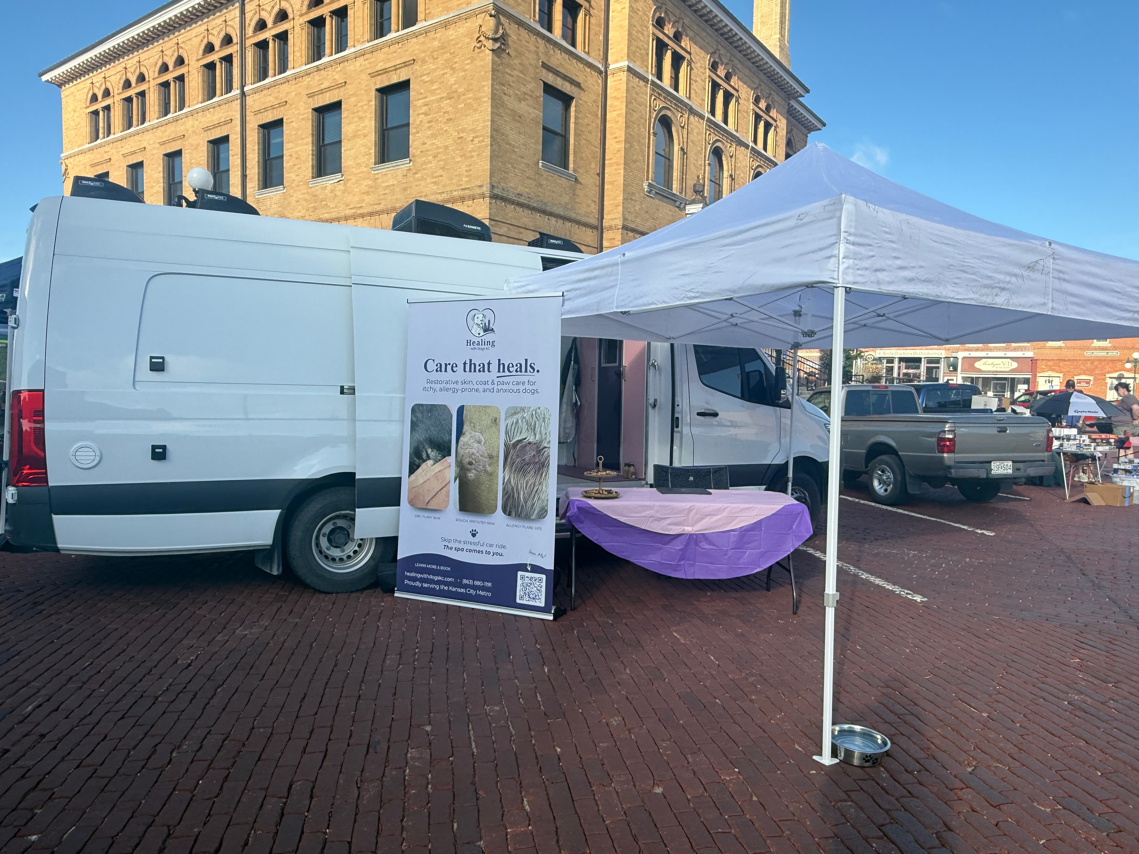 Healing with Dogs KC mobile spa van and community booth at a Kansas City metro event