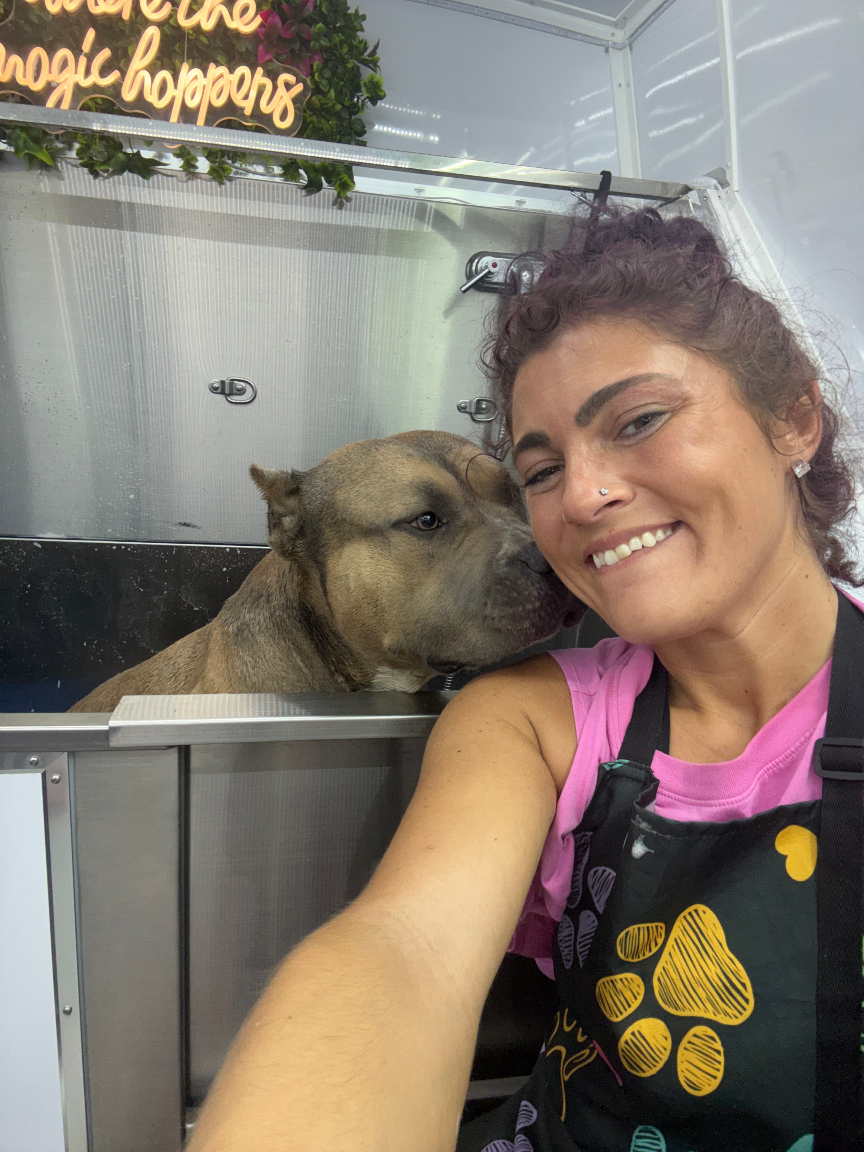 Jamie smiling with a dog in the Healing with Dogs KC mobile grooming spa