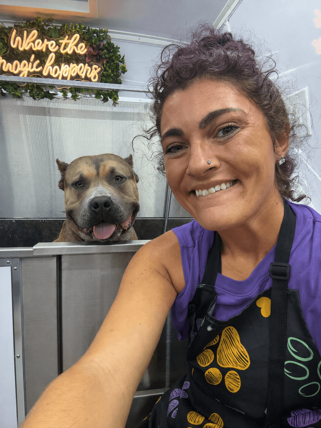 Jamie smiling with a dog in the Healing with Dogs mobile spa